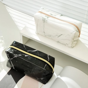 Detail of marble pattern PU leather pencil cases with elegant gold zipper closures