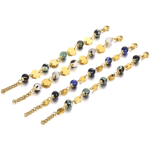 Set of four gold metal disk bracelets with colorful resin beads on white background