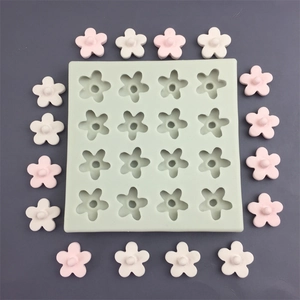Macro shot of 16-cavity silicone flower mold with pink and white finished floral crafts