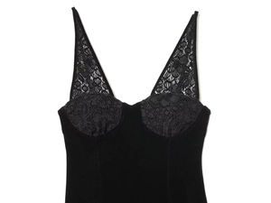 Close-up of black velvet dress featuring delicate lace trim and deep V-neckline detail