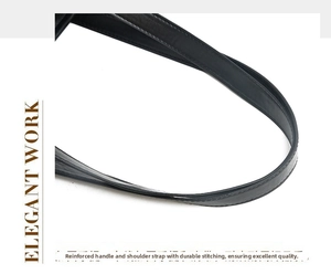 Detailed macro view of reinforced stitching on black leather tote bag handle