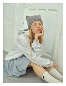 Detailed look at gray cat ear knit hat paired with white hoodie and bow socks outfit