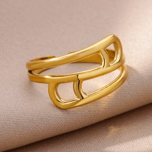 Macro view of geometric cutout open ring with 18k gold plating on silk fabric