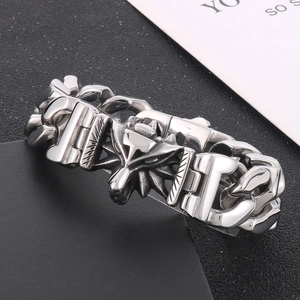 Macro detail of gothic wolf head charm and heavy square links on stainless steel bracelet