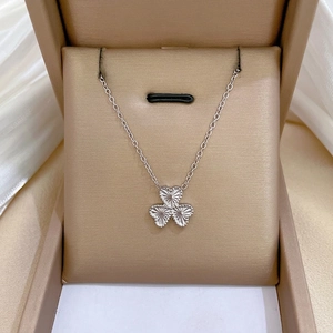 Minimalist silver clover necklace with laser engraved heart petals in luxury gift box