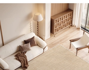 A cozy living room corner featuring a neutral brown woven carpet under a beige fabric sofa