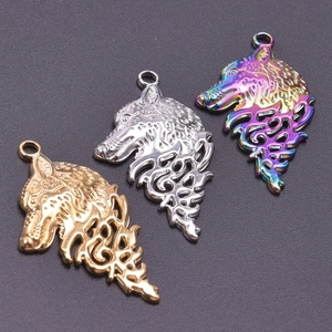 Detailed view of punk style wolf head pendants in gold, silver, and iridescent finishes