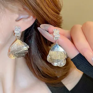 Exaggerated silver petal tassel earrings with square cubic zirconia and brushed metal finish