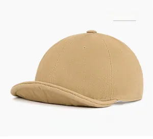 Detailed close-up of khaki short brim cap featuring herringbone cotton texture and stitching