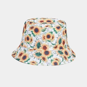 Close-up of vibrant sunflower patterns and durable cotton fabric on a white bucket hat