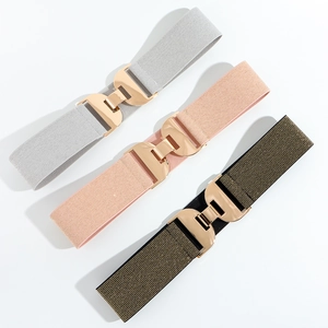 Three elastic woven belts in grey, pink, and olive green with golden geometric buckles