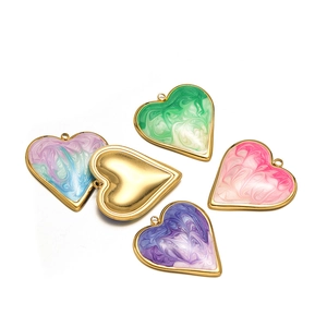 Macro shot of colorful heart-shaped pendants with marble texture and gold metal base