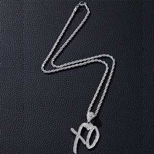 Macro shot of silver hiphop XO pendant with sparkling micro-pave cubic zirconia crystals