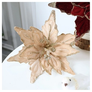 Close-up of champagne velvet poinsettia with gold glitter edges for Christmas decor
