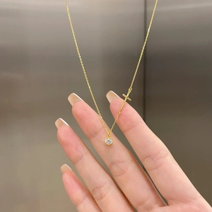 Detailed view of S925 silver gold necklace with small cross and zircon pendant charms
