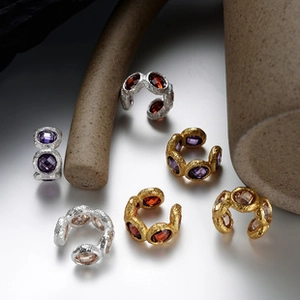 Detailed shot of S925 sterling silver ear cuffs with hammered texture and colorful gemstones
