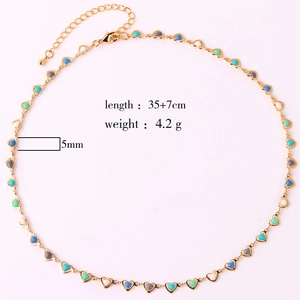Detail view of gold necklace with multi-colored heart charms and 35+7cm length specs