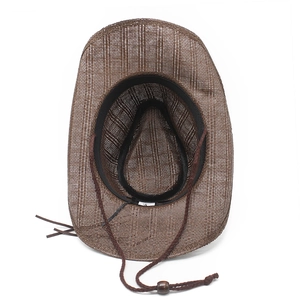 Detail of woven straw cowboy hat showing interior sweatband and adjustable chin strap