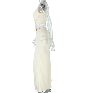 Side view detail of a beige one-shoulder sleeveless maxi dress with a long thigh-high slit