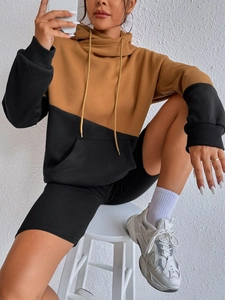Brown and black color-block oversized drawstring hoodie styled with black biker shorts