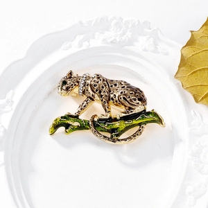 Macro detail of leopard brooch with leopard spots and rhinestones on decorative branch