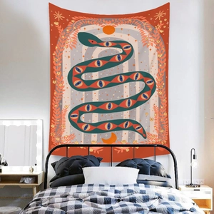 Bohemian tapestry featuring mystic serpent and moon stars hanging over a bedroom wall