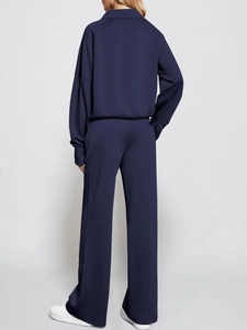Rear view of deep blue two-piece lounge set with high-collar sweatshirt and wide-leg pants