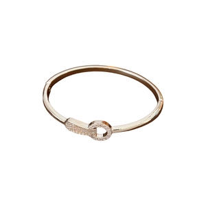 Rose gold plated zircon bangle with sparkling pavé snap closure on white background