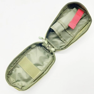 Detailed interior of green nylon tactical medical pouch with elastic loops and red pull tab