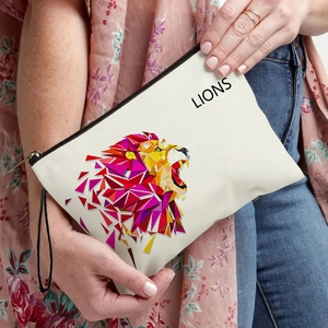 Canvas makeup bag featuring a geometric lion print with a black zipper and wristlet