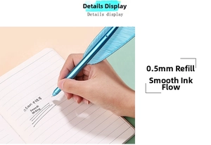 Close-up of blue metallic feather pen writing smoothly on a notebook with a 0.5mm tip