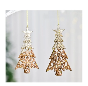 Close-up of glittery hollow Christmas tree ornaments with gold to silver gradient effect