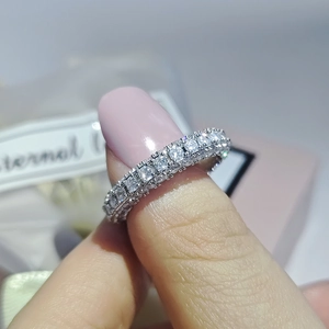 Close-up of eternity band ring with three-sided zircon inlay and eternal ribbon box