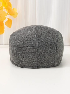 Detailed back view of a dark grey linen newsboy cap showing woven texture and stitching