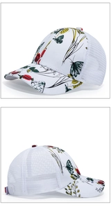Detail of white trucker hat featuring butterfly and berry prints with breathable mesh