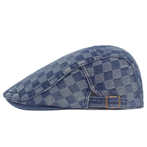 Detail view of denim checkered beret featuring adjustable metal buckle and retro texture