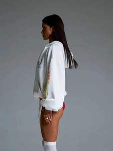 Detail of white oversized hoodie showing heavy cotton fabric and colorful sleeve stripes