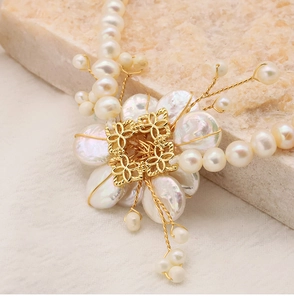 Macro detail of baroque pearl flower pendant with intricate gold wire handmade craftsmanship