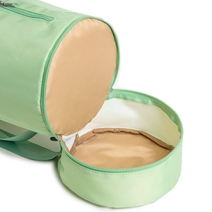Light green cylindrical yoga mat bag with a front zipper opening and beige lining