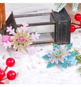 Detail of glitter snowflake hair clips with faux gemstones in pink and blue colors