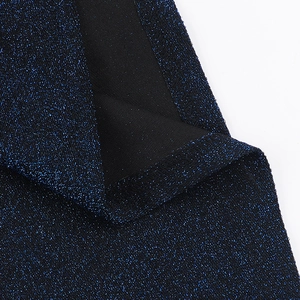Détail du tissu pailleté bleu marine montrant la maille fine et les finitions
