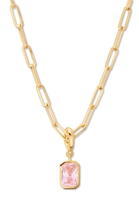 Close-up of a pink emerald-cut gemstone pendant on a gold-plated paperclip chain necklace