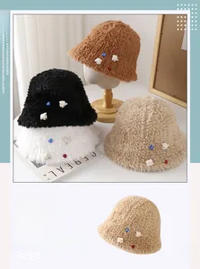 Close-up of plush bucket hats with cute bear patches and colorful hearts in soft faux fur