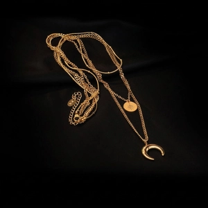 Three-layer gold layered necklace with star coin and crescent moon charms on black silk