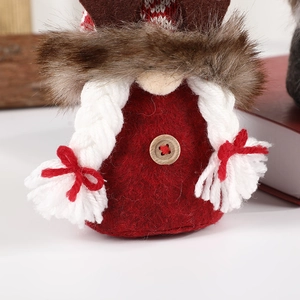 Christmas reindeer plush ornament with red knitting and felt details on white background