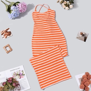 Detailed top view of striped knit maxi dress with halter ties on a neutral background