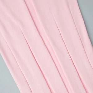 Detail of pink ribbed knit fabric showing soft texture and high-density weaving