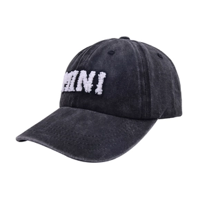 Close-up of vintage washed black cotton baseball cap featuring white 3D letter embroidery