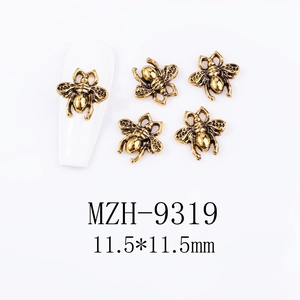 Macro detail of retro golden bee nail charms with 11.5mm size and vintage alloy texture