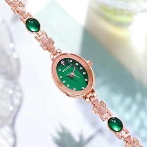 Luxury rose gold women's watch with emerald green dial and crystal-set metal strap
